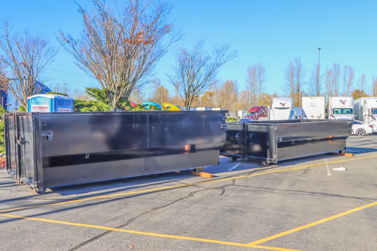 Professional dumpster rental service with roll-off container on residential driveway in Novi